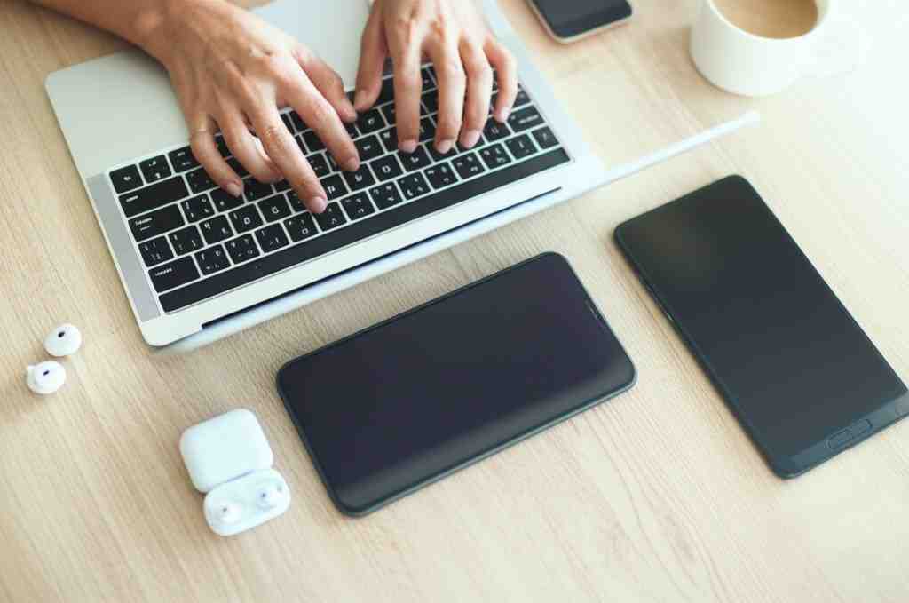 About Us A person writing on a laptop with tech gear